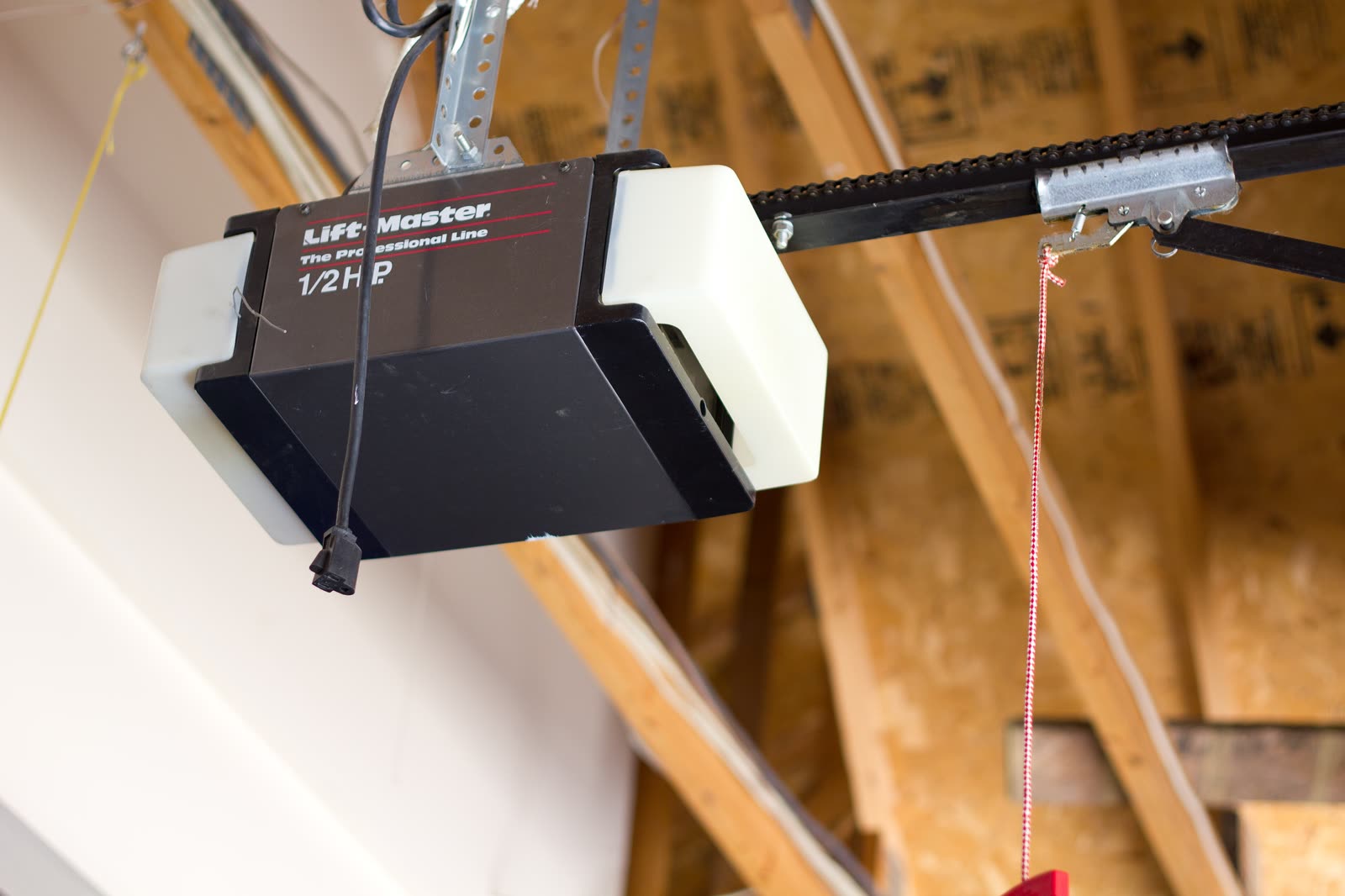 Ceiling-mounted chain-drive garage door opener with its rail