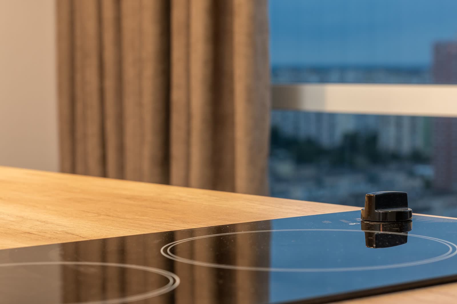 Smooth glass electric cooktop built into a wooden counter
