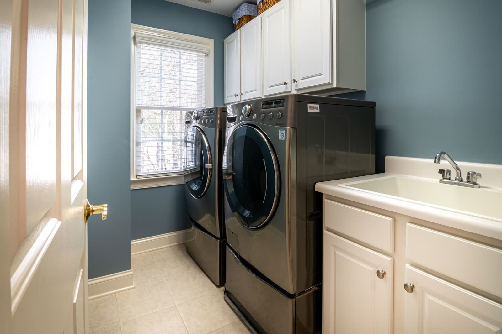 Front-load washer and dryer pair in a home laundry room
