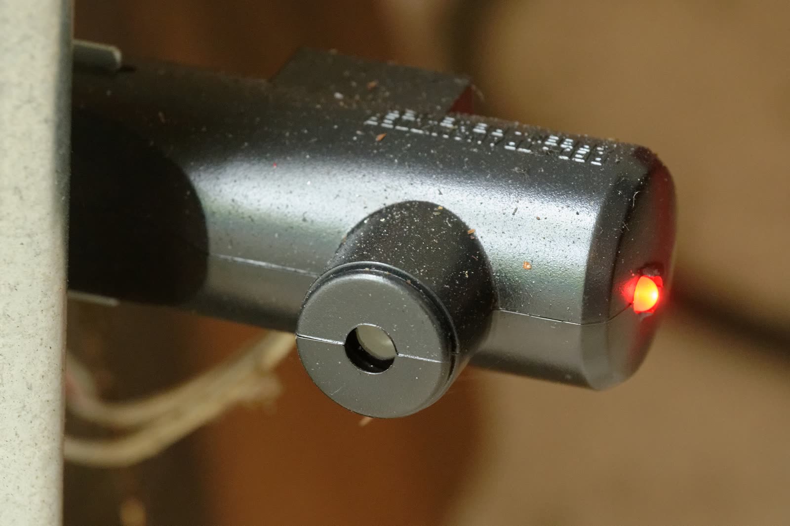 Garage door safety sensor (photo eye) with its indicator light on