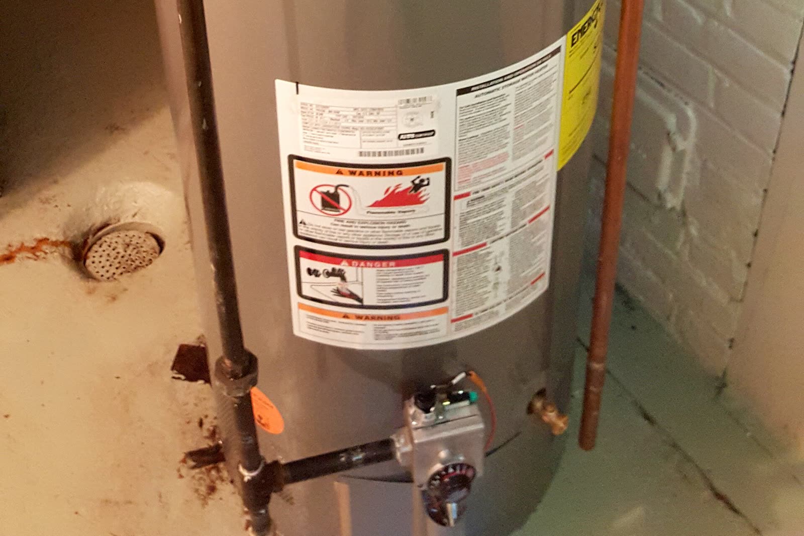 Newly installed gas tank water heater with its flue, gas line and water connections