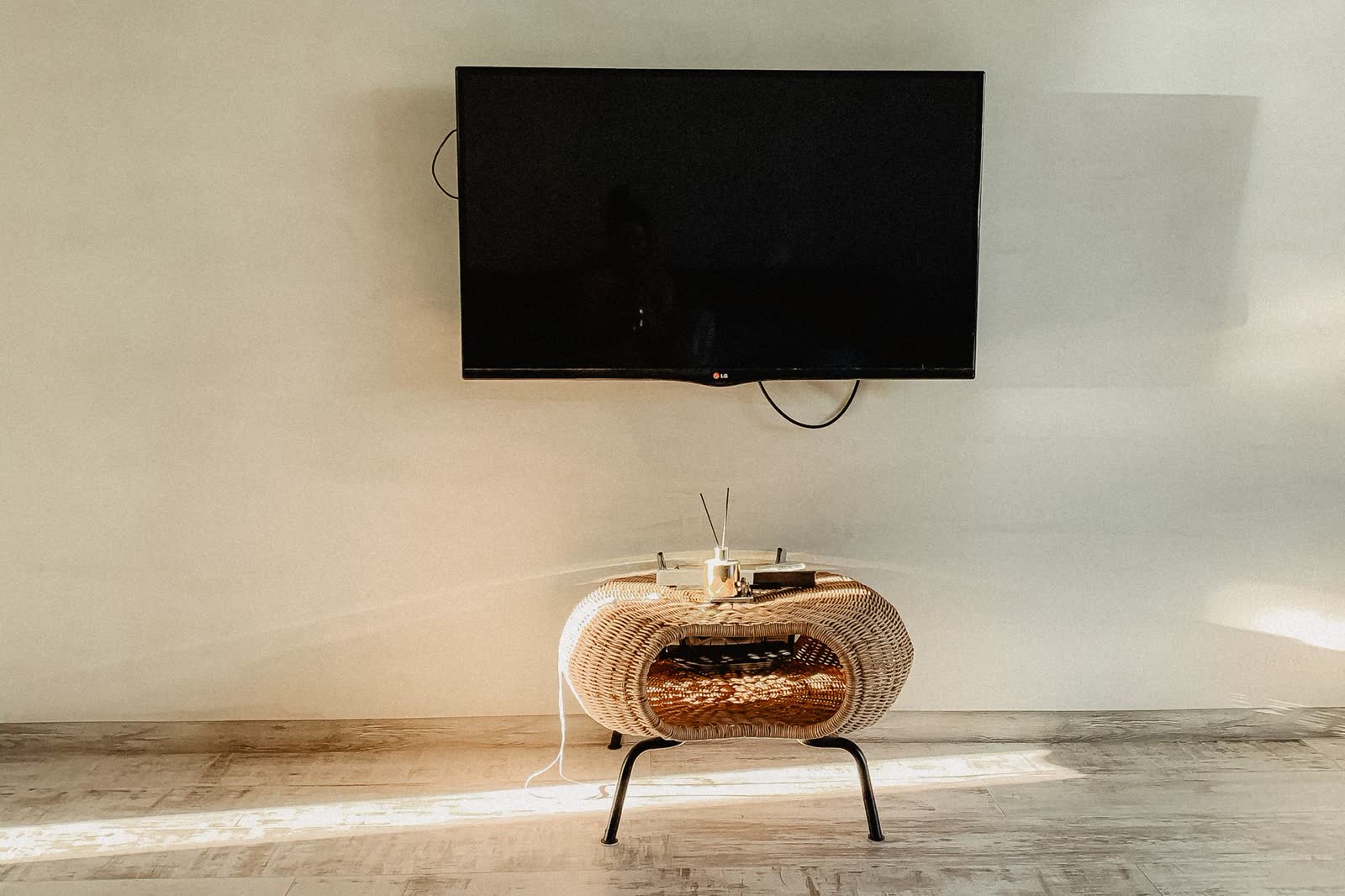 Flat-panel TV mounted on a living room wall with the screen off