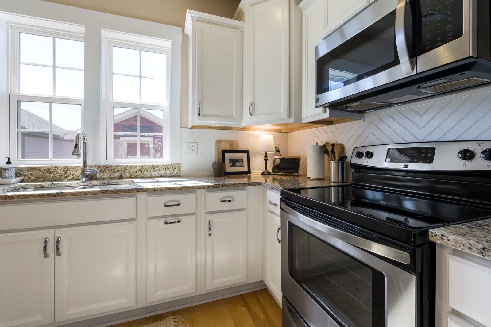 Over-the-range microwave mounted above a stainless electric range