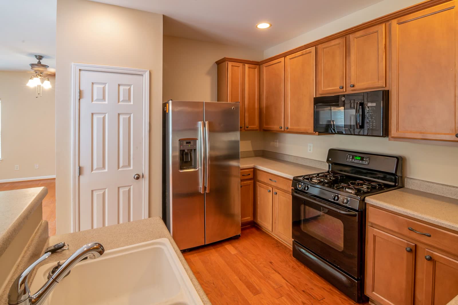Stainless side-by-side refrigerator in a kitchen with wood cabinets