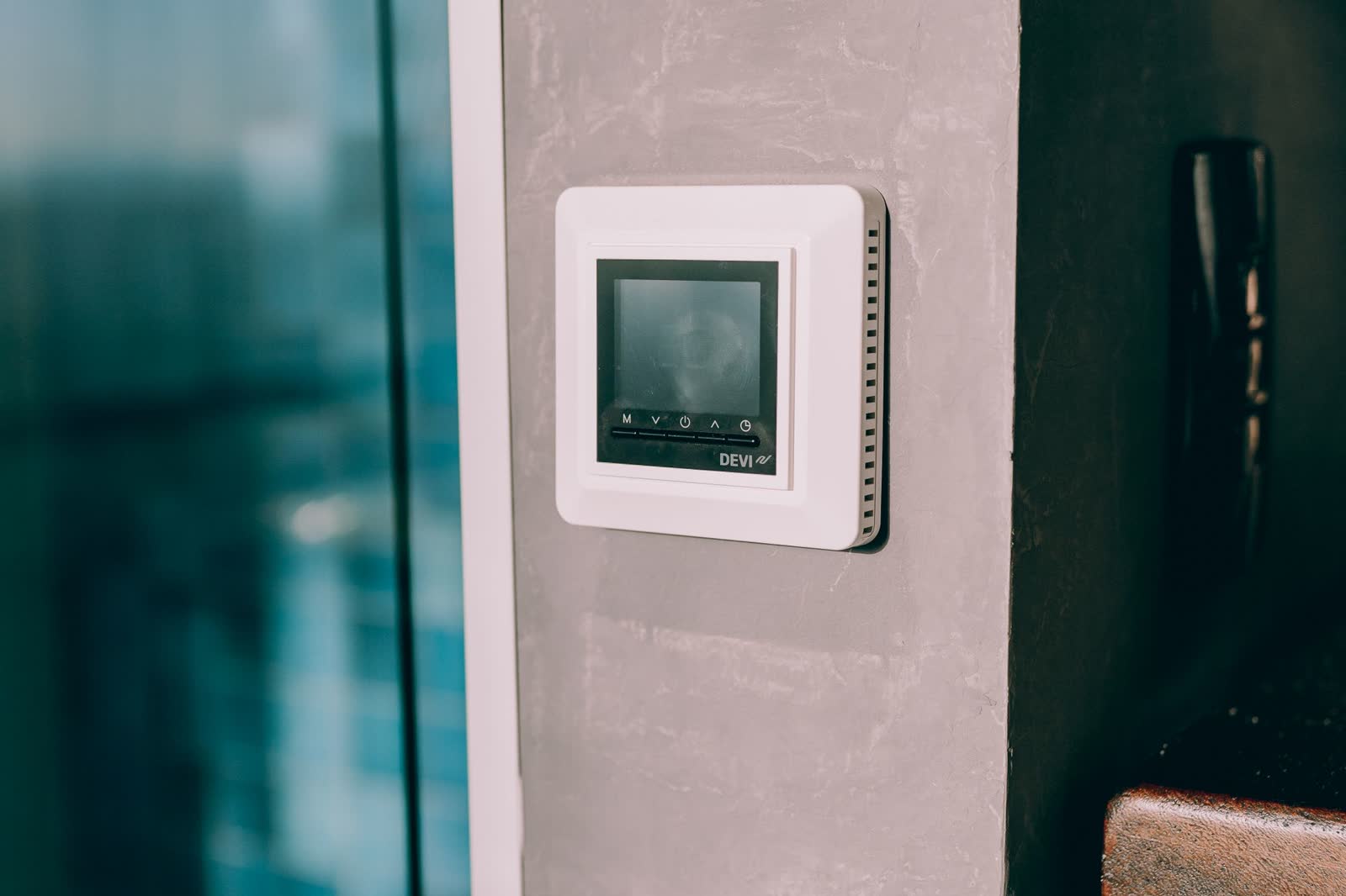 Digital thermostat mounted on a concrete wall