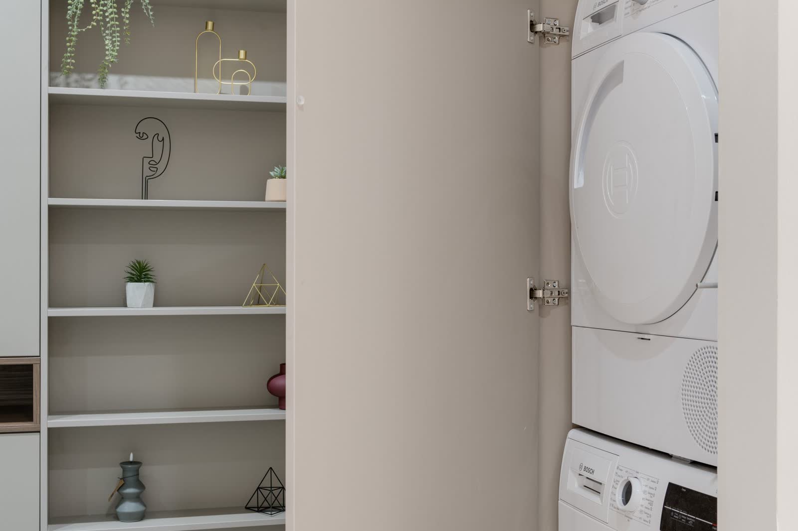 Stacked washer and dryer installed inside a cabinet closet