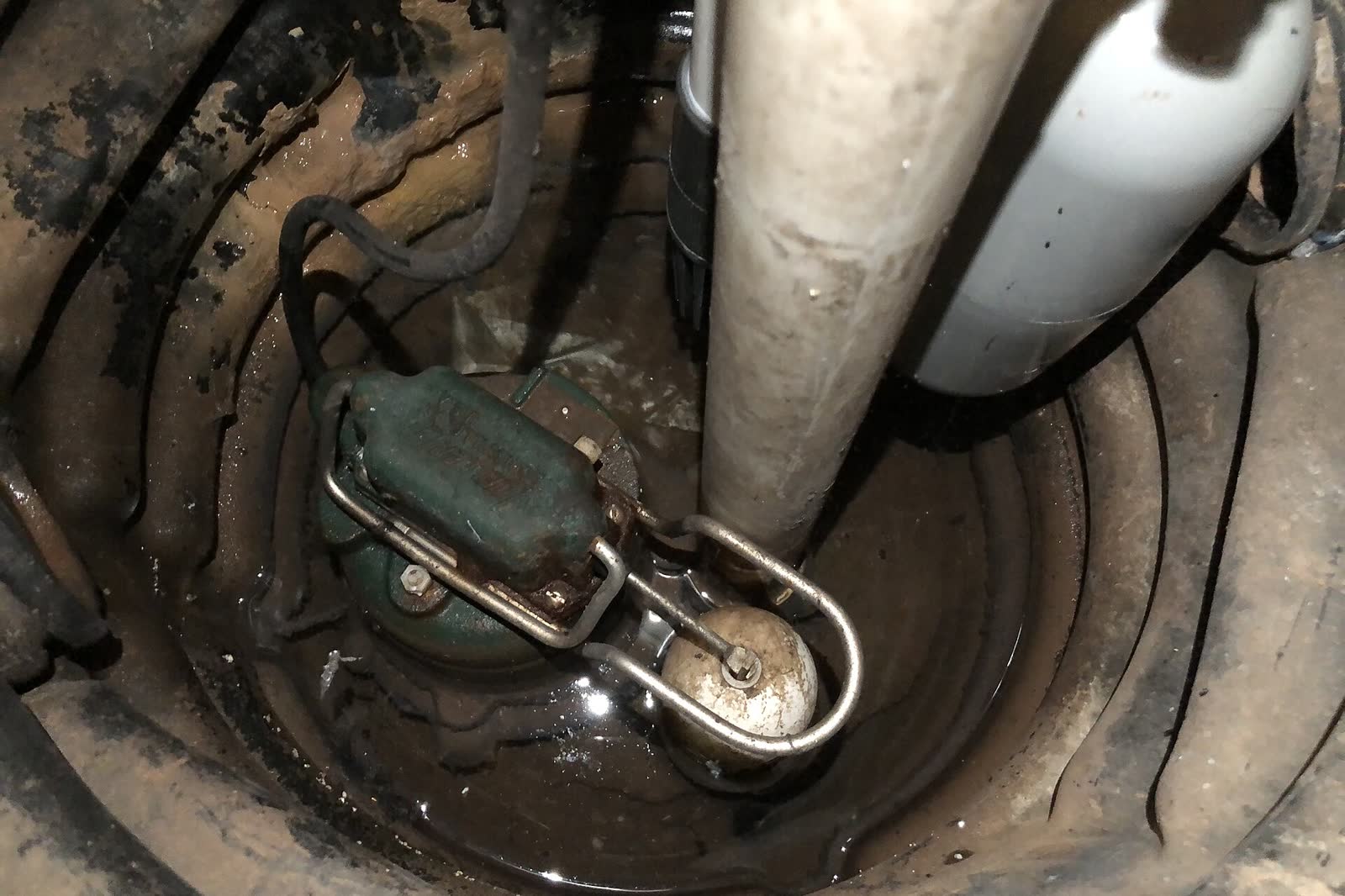 Newly installed sump pump sitting in a basement sump pit