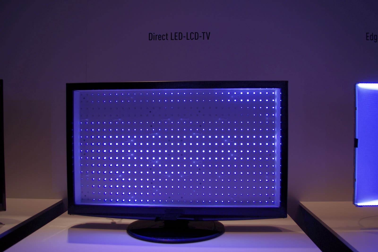LCD TV with the panel removed, showing the grid of lit LED backlights