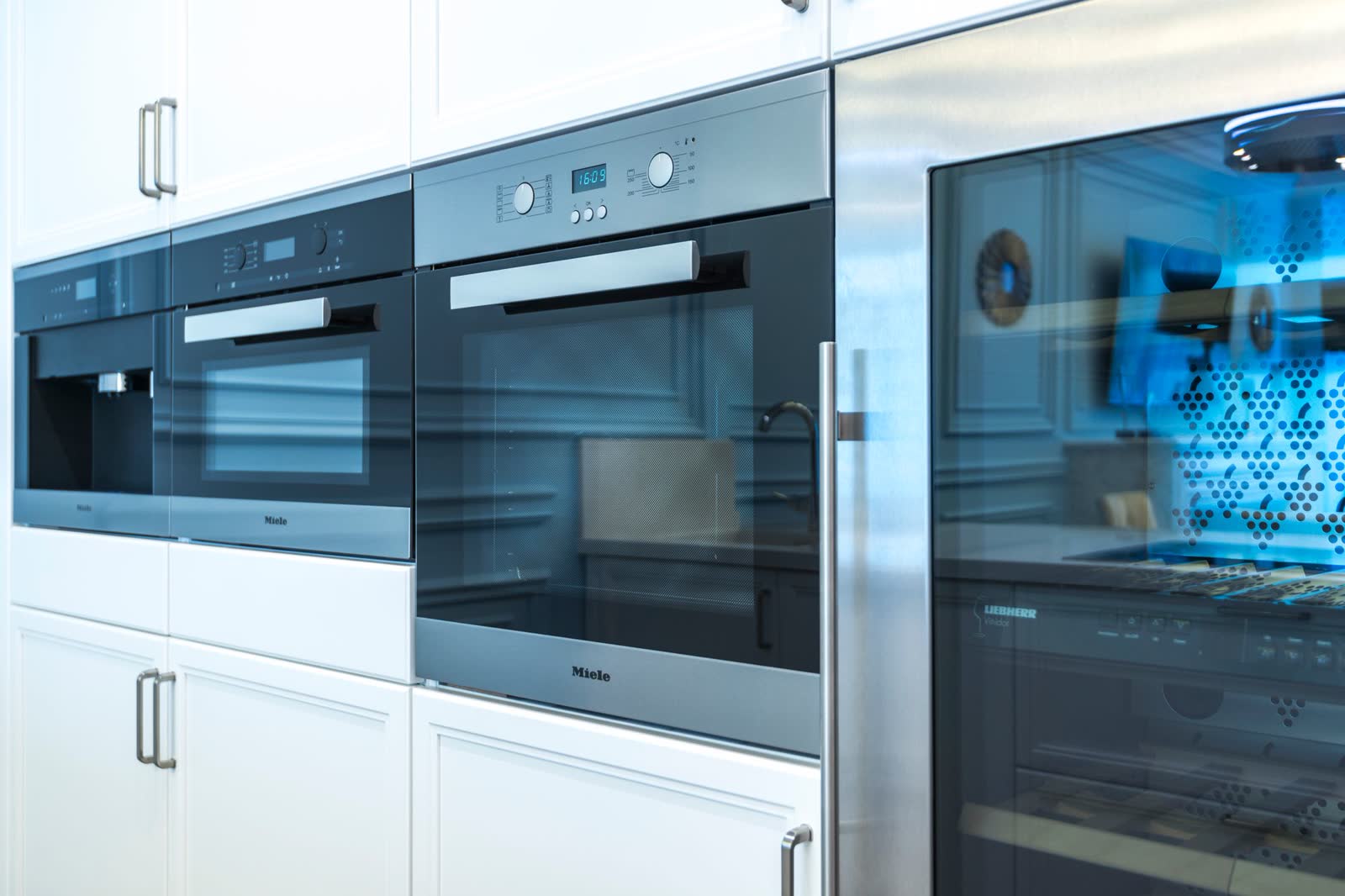 Row of built-in wall ovens in a modern kitchen