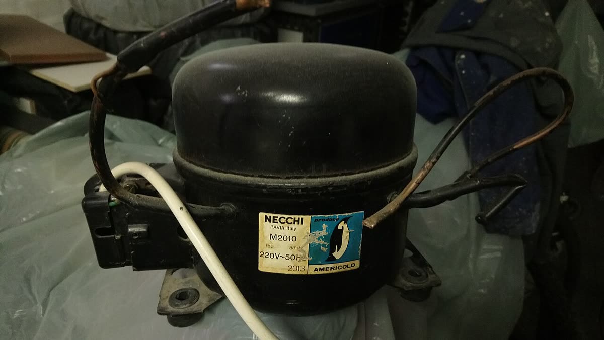 Hermetic refrigerator compressor, the black sealed unit at the back bottom of a fridge