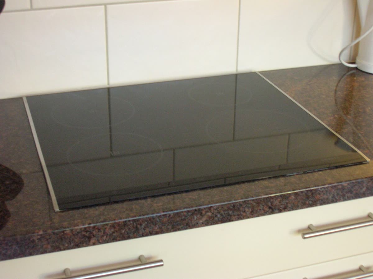 Glass induction cooktop with marked cooking zones