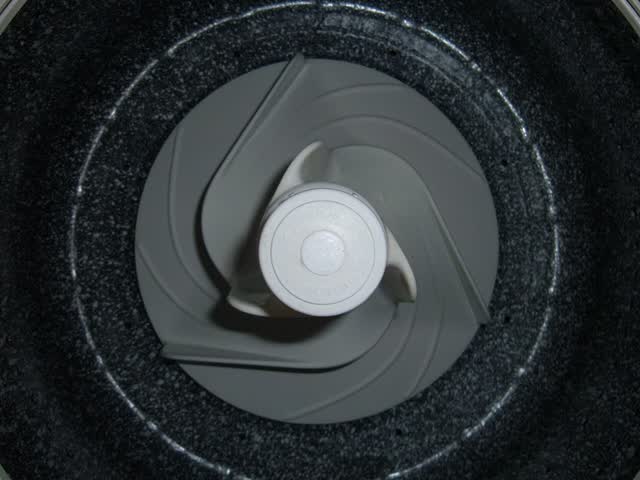 Top-load washer low-profile agitator/impeller at the bottom of the wash basket