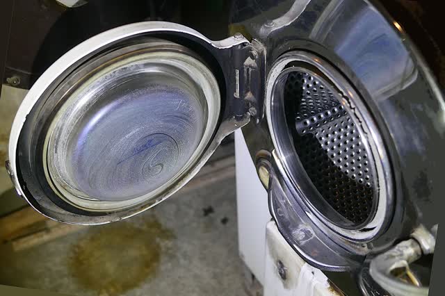 Front-load washer with the door open, showing the door glass and the rubber door boot seal