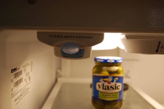 Water filter cartridge installed inside a refrigerator