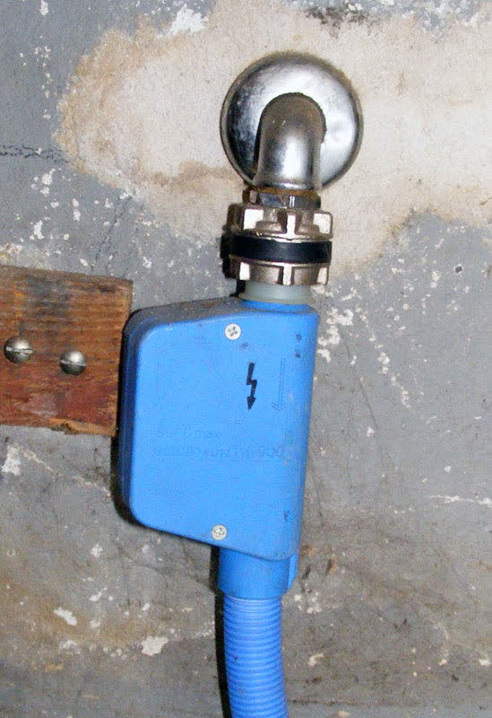 Washer fill hose with a safety shutoff (Aquastop) valve connected to the cold-water tap
